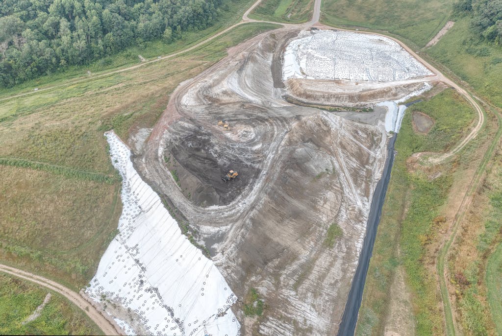 Aerial view of a construction site in Alma, Wisconsin, featuring earthworks and machinery.