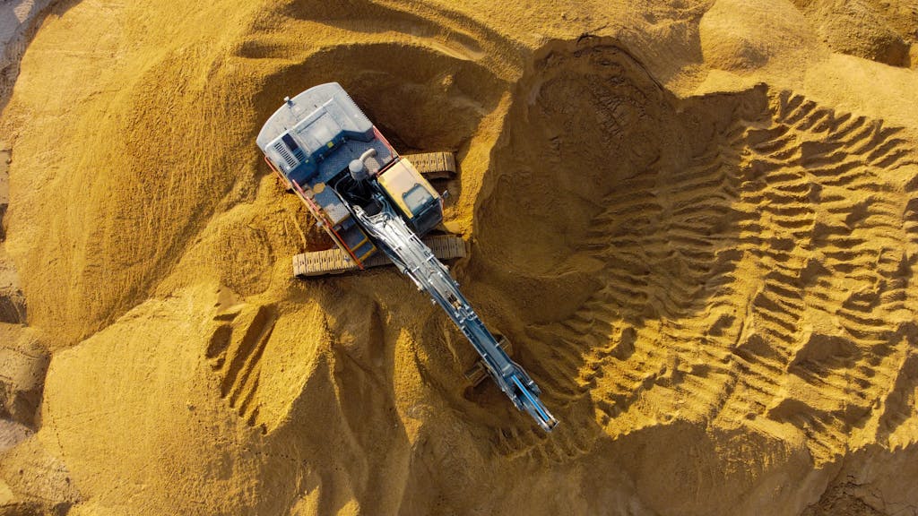 Drone captures an excavator digging sand in Ashdod, highlighting industrial activity.