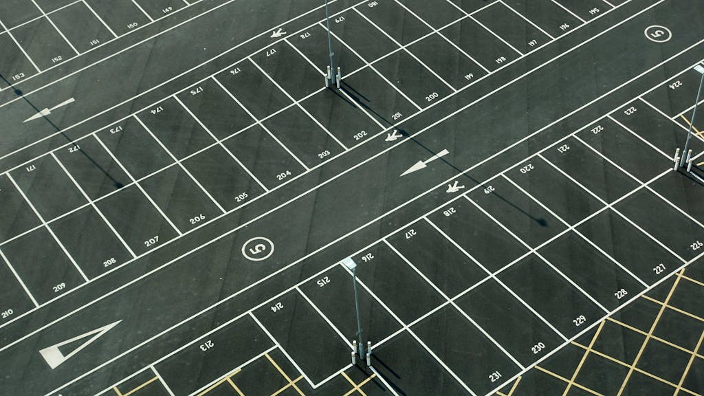 Aerial view of an empty parking lot with numbered spaces in London.