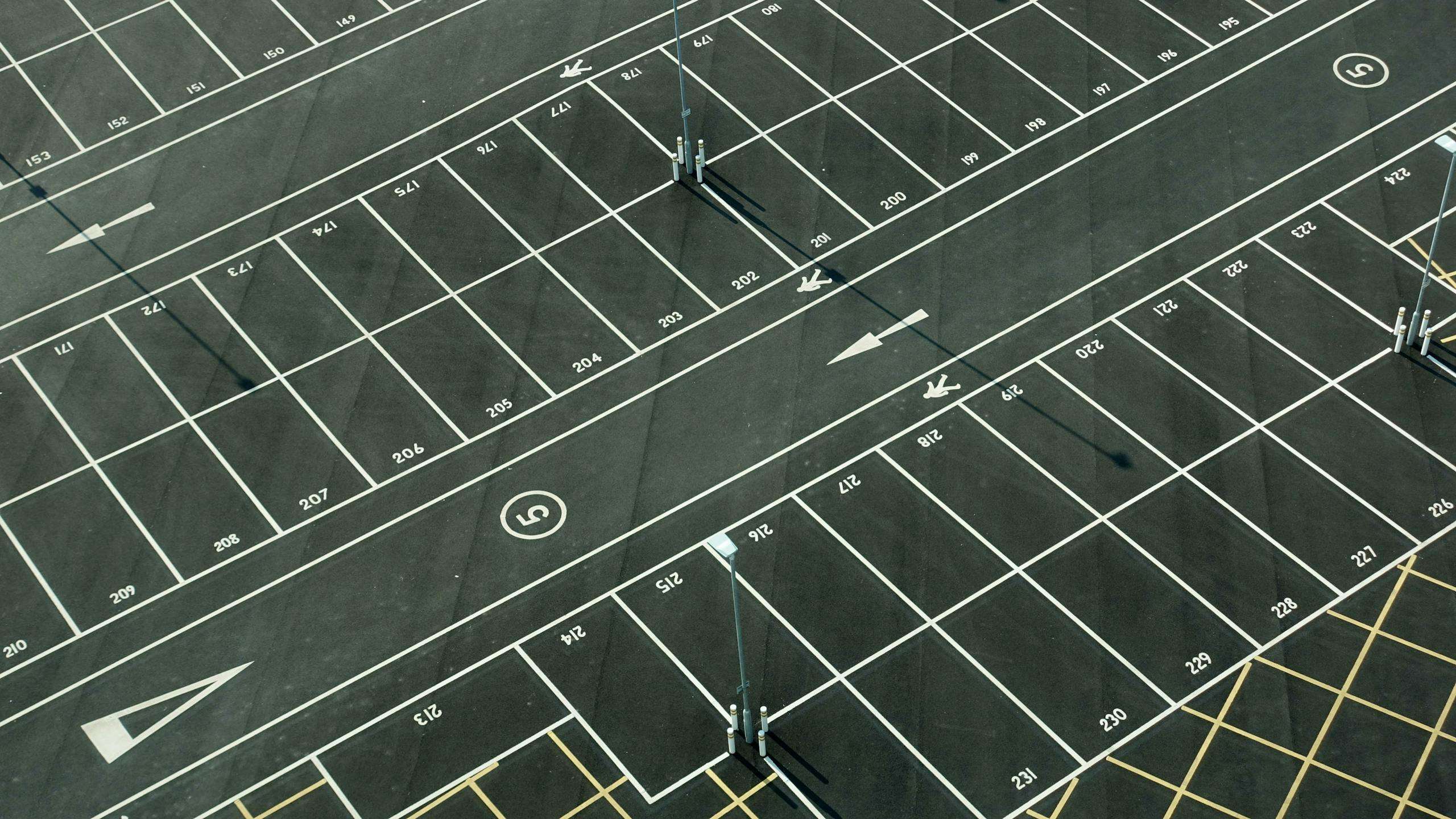 Aerial view of an empty parking lot with numbered spaces in London.
